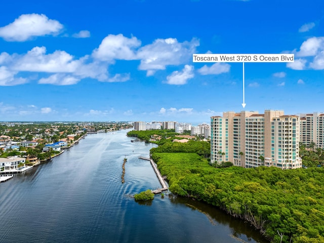 birds eye view of property with a city view and a water view