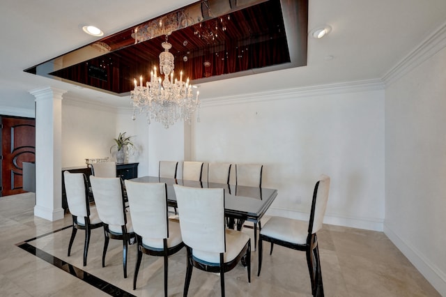 tiled dining space featuring a raised ceiling, decorative columns, and a chandelier