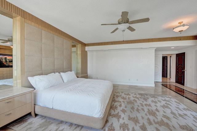 bedroom featuring tile walls, ceiling fan, and light tile patterned floors