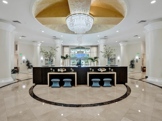 reception with a notable chandelier and ornate columns