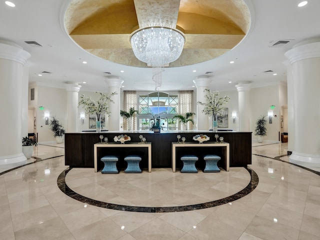 reception area with a notable chandelier, decorative columns, and visible vents