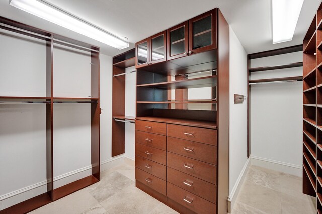 spacious closet featuring light tile patterned floors