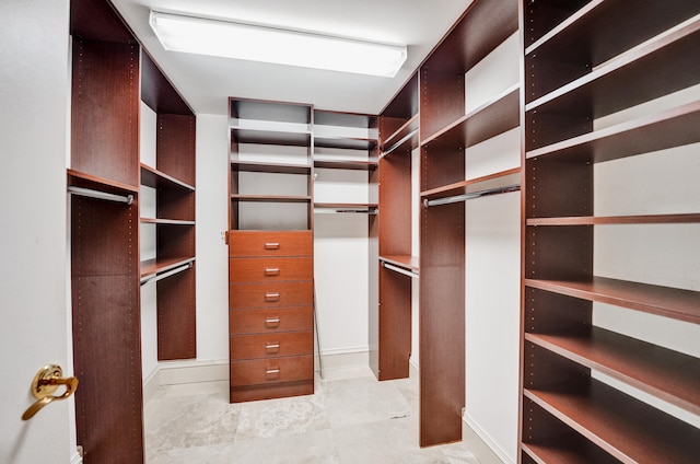 spacious closet with light tile patterned floors