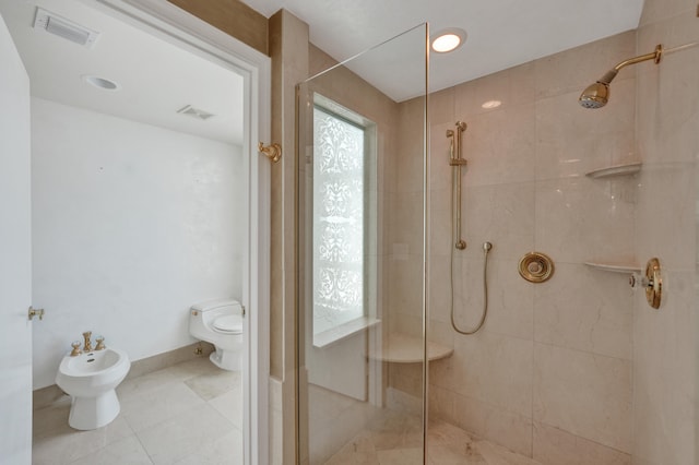 bathroom featuring tile patterned flooring, toilet, a bidet, and walk in shower