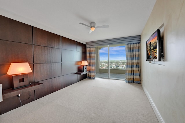 interior space with light colored carpet and ceiling fan