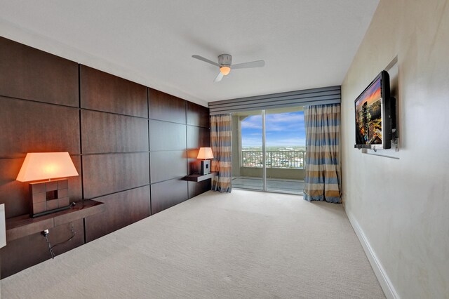 sitting room featuring carpet floors, a ceiling fan, and baseboards