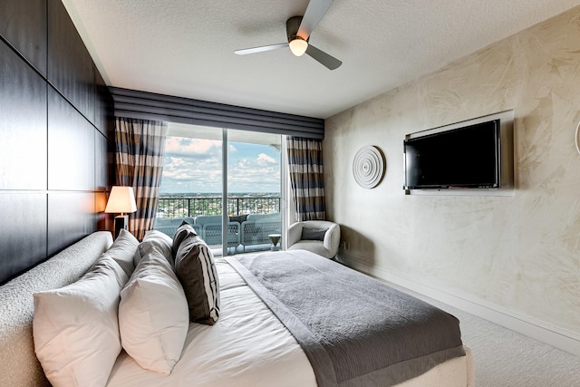 bedroom with ceiling fan, carpet flooring, a textured ceiling, and access to exterior