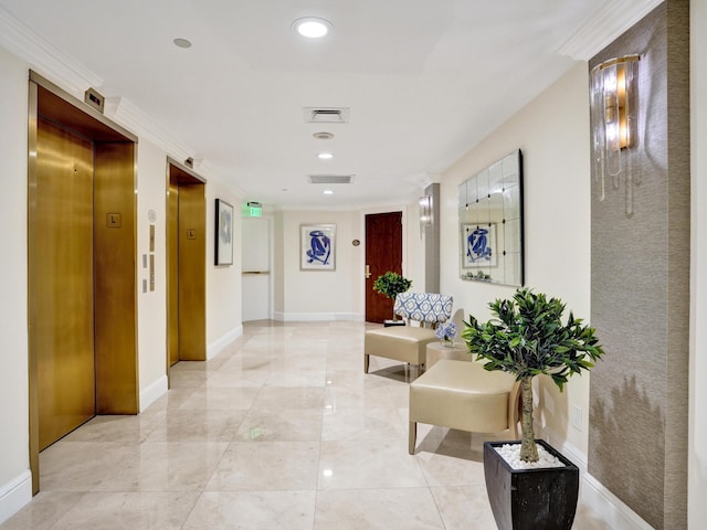 hallway with elevator, visible vents, and baseboards