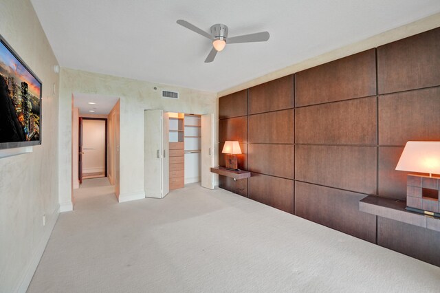 interior space featuring ceiling fan and light carpet