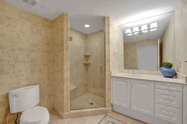 bathroom with tile patterned floors, toilet, walk in shower, and vanity