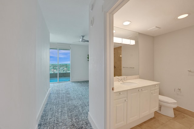 bathroom with toilet, vanity, and tile patterned floors