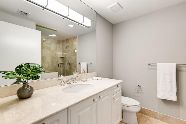 bathroom featuring tile patterned flooring, a shower with door, toilet, and vanity