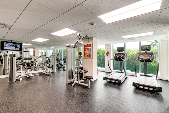 workout area featuring a drop ceiling and plenty of natural light