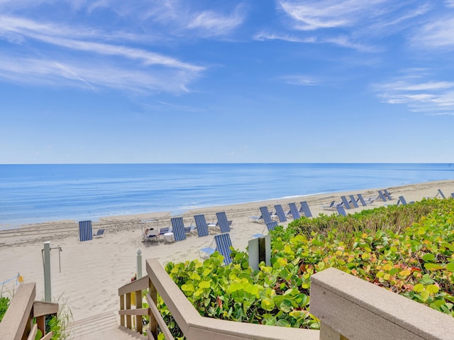 property view of water featuring a boat dock and a view of the beach