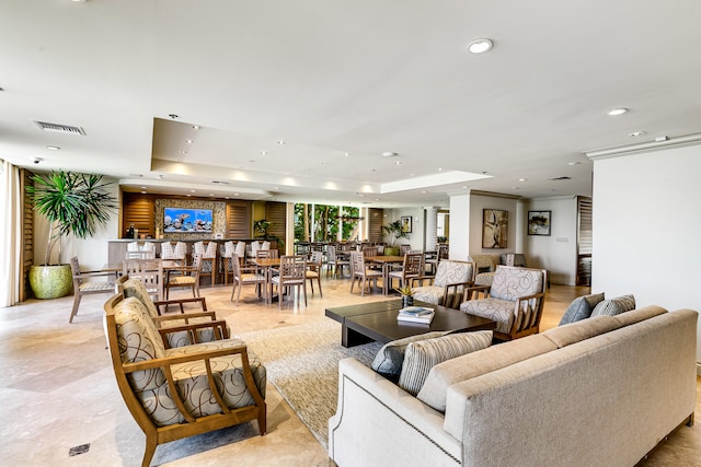 tiled living room featuring a raised ceiling