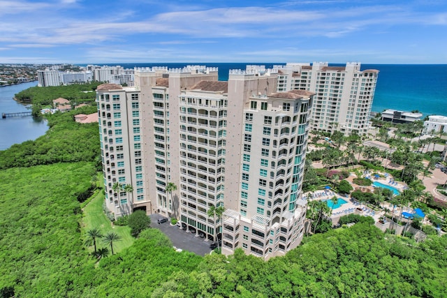 view of building exterior with a water view and a city view