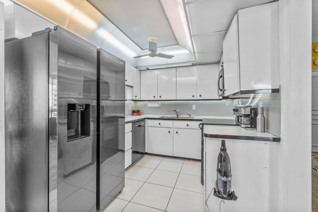 kitchen with ceiling fan, tasteful backsplash, appliances with stainless steel finishes, and white cabinets