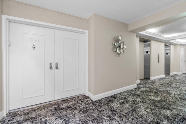 entryway featuring elevator and carpet floors