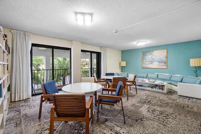 dining area featuring a textured ceiling