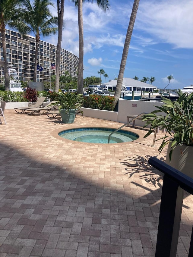 view of swimming pool with a patio and a hot tub