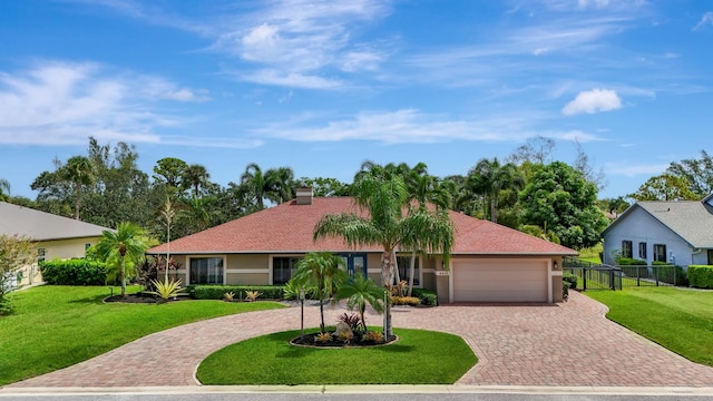 single story home with a garage and a front lawn