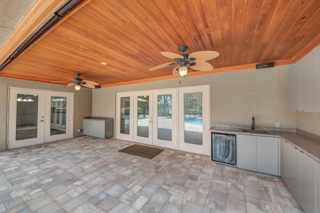 view of patio / terrace with ceiling fan, french doors, and sink