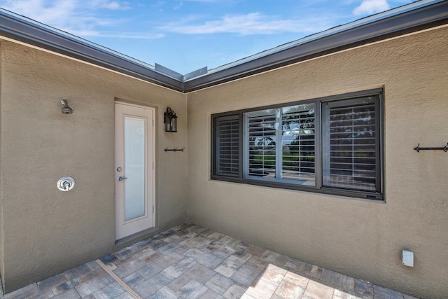 view of exterior entry featuring a patio