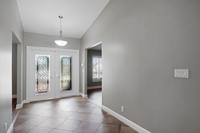 foyer entrance with hardwood / wood-style flooring, french doors, and lofted ceiling