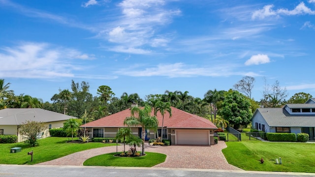 ranch-style house featuring a garage and a front lawn