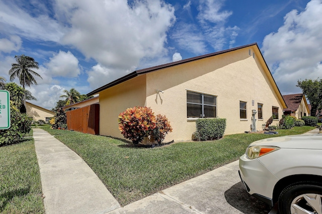 view of side of home with a lawn