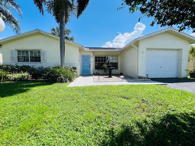 single story home featuring a garage and a front yard