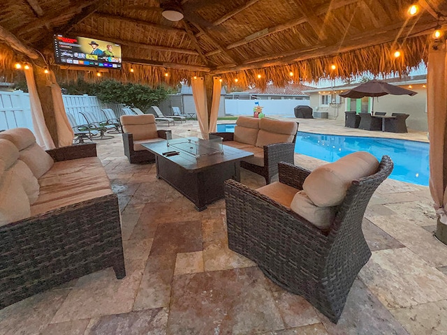 view of patio featuring a gazebo, an outdoor hangout area, ceiling fan, and a fenced in pool