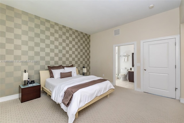 carpeted bedroom with ensuite bath