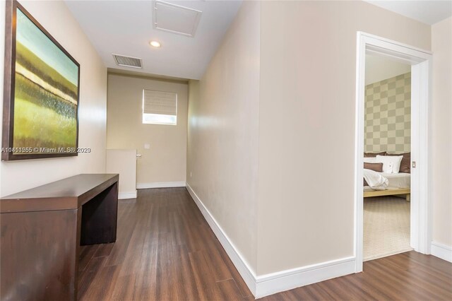 corridor with dark wood-type flooring