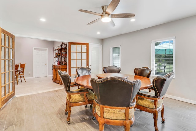 dining area with ceiling fan and light hardwood / wood-style flooring