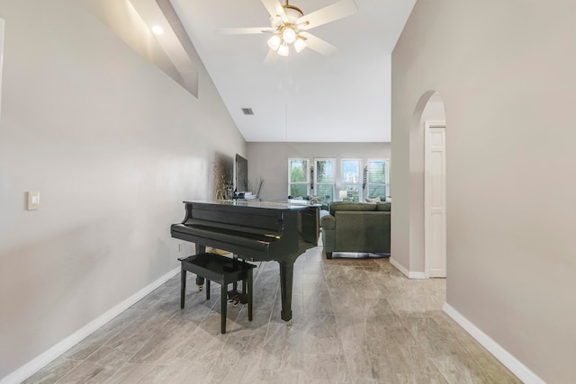 miscellaneous room with ceiling fan and high vaulted ceiling