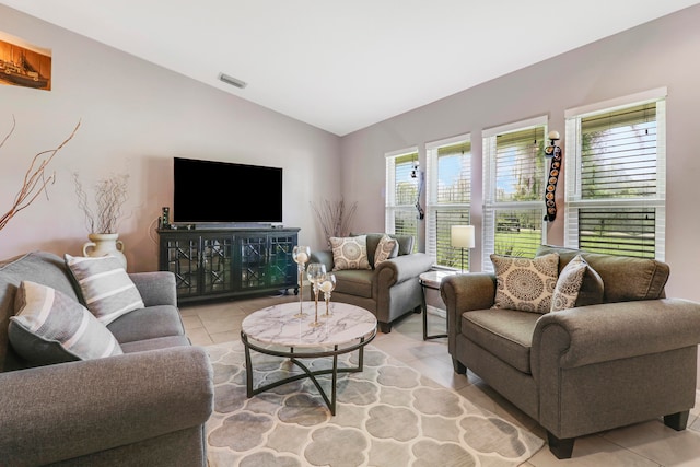 tiled living room featuring vaulted ceiling