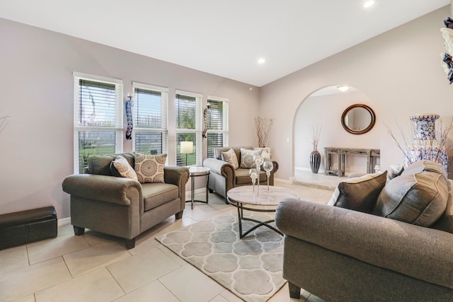 living room with a wealth of natural light and light tile patterned flooring