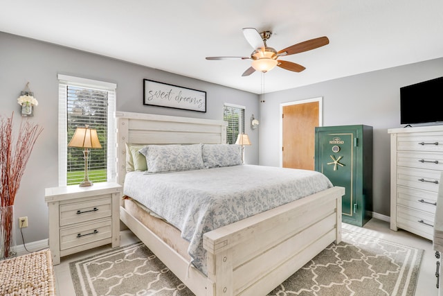 bedroom featuring multiple windows and ceiling fan