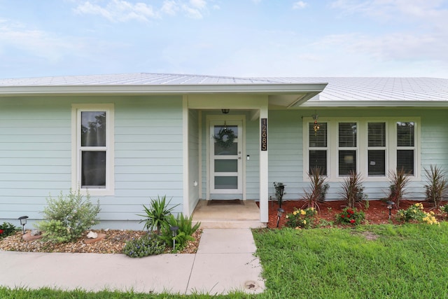 property entrance with a yard