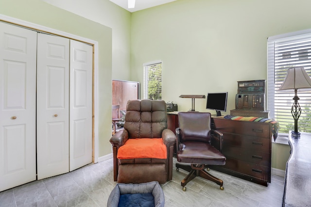 sitting room featuring light tile patterned flooring and a high ceiling