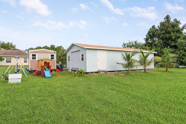 view of yard with a playground and an outbuilding