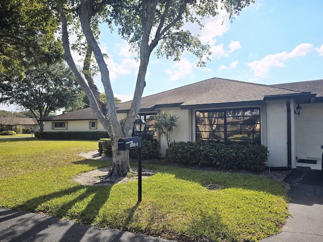 4908 Eaglewood Rd Unit A, Boynton Beach, FL 33436 - view of front of property featuring a front lawn, stucco siding, and roof with shingles