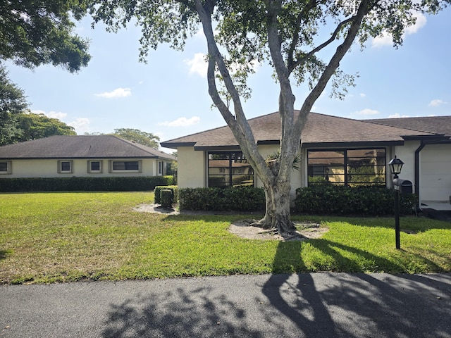 4908 Eaglewood Rd Unit A, Boynton Beach, FL 33436 - ranch-style house with stucco siding and a front yard