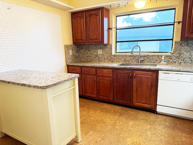 4908 Eaglewood Rd Unit A, Boynton Beach, FL 33436 - kitchen featuring white dishwasher, light floors, light stone countertops, a sink, and decorative backsplash