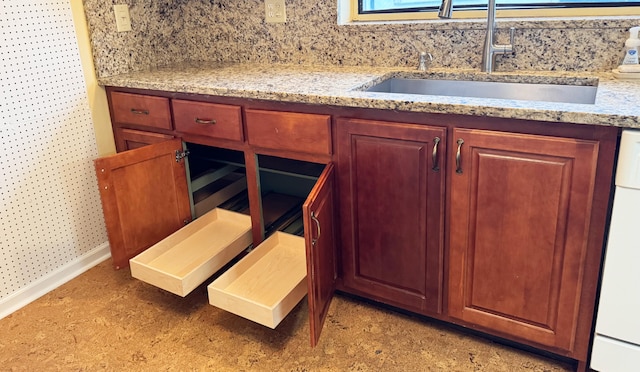 4908 Eaglewood Rd Unit A, Boynton Beach, FL 33436 - interior details with baseboards, white dishwasher, decorative backsplash, and a sink