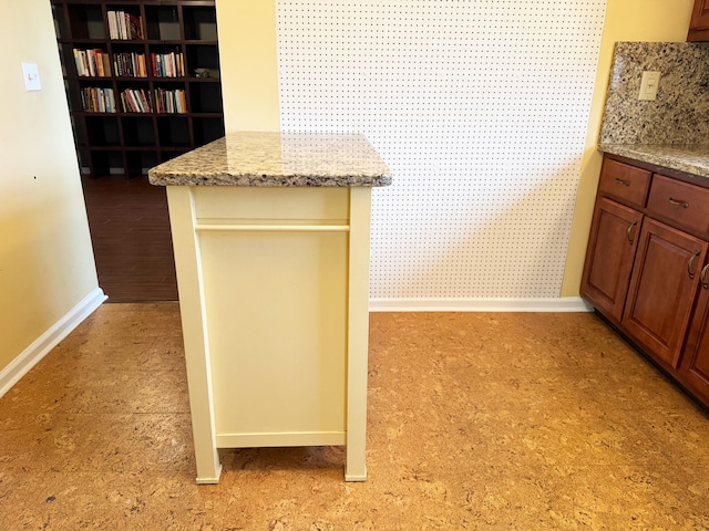 4908 Eaglewood Rd Unit A, Boynton Beach, FL 33436 - kitchen featuring baseboards and light stone counters