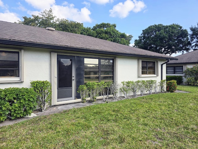 4908 Eaglewood Rd Unit A, Boynton Beach, FL 33436 - entrance to property featuring a yard, a shingled roof, and stucco siding