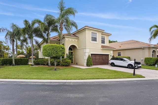 mediterranean / spanish home with a garage and a front yard