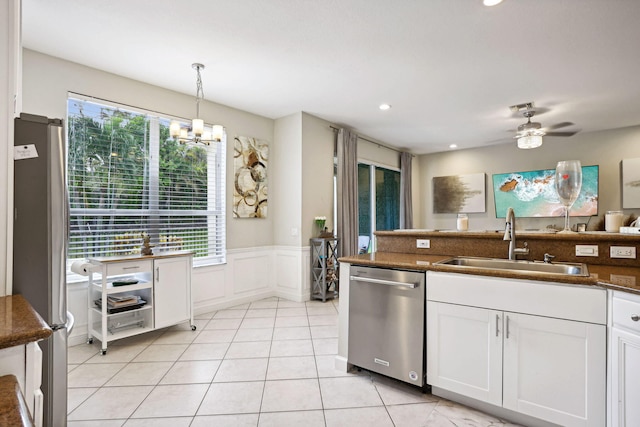 kitchen featuring sink, ceiling fan with notable chandelier, a healthy amount of sunlight, and stainless steel appliances